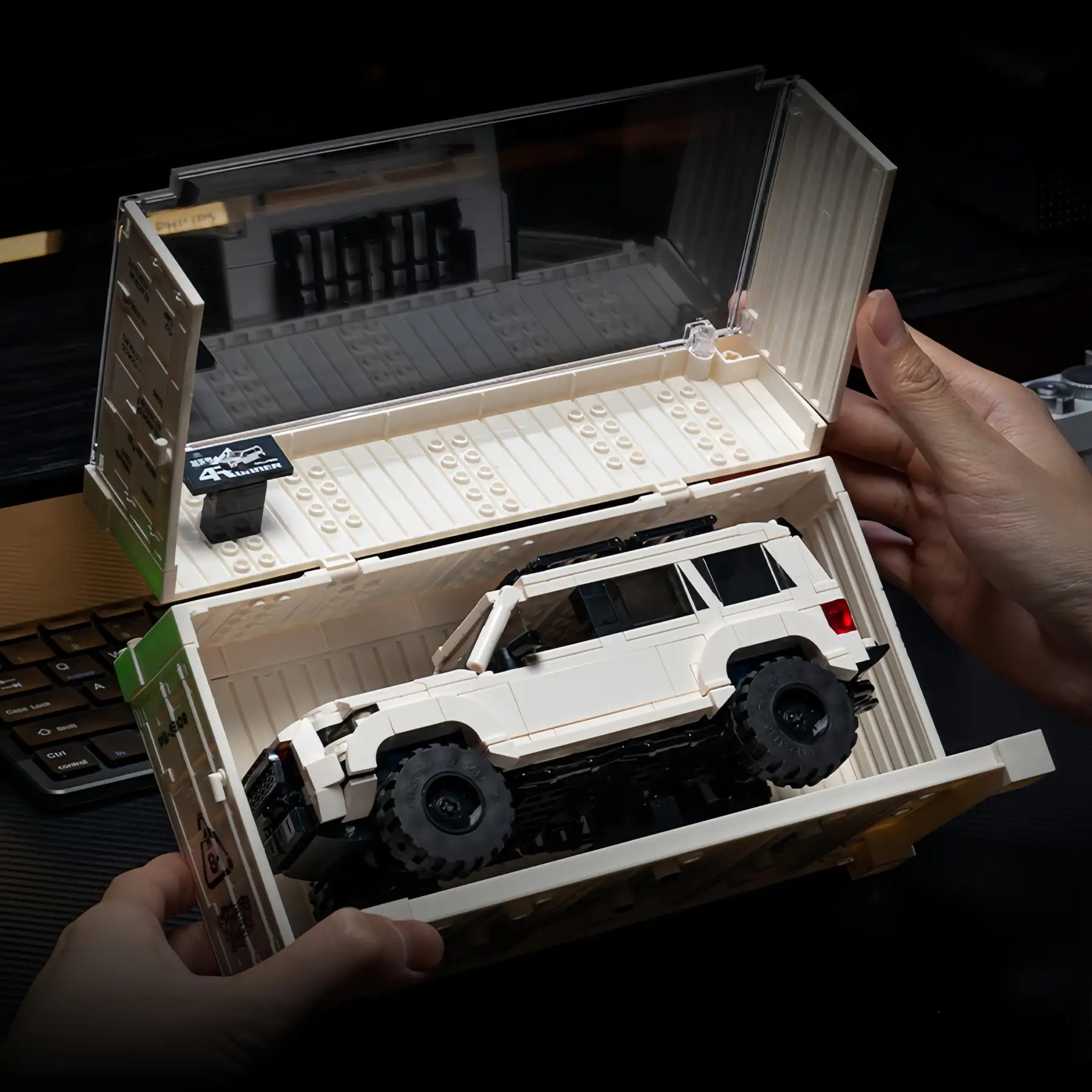 Hands holding open display case with white Toyota 4Runner Off-Road SUV Brick Model, 540 PCS collectible construction set