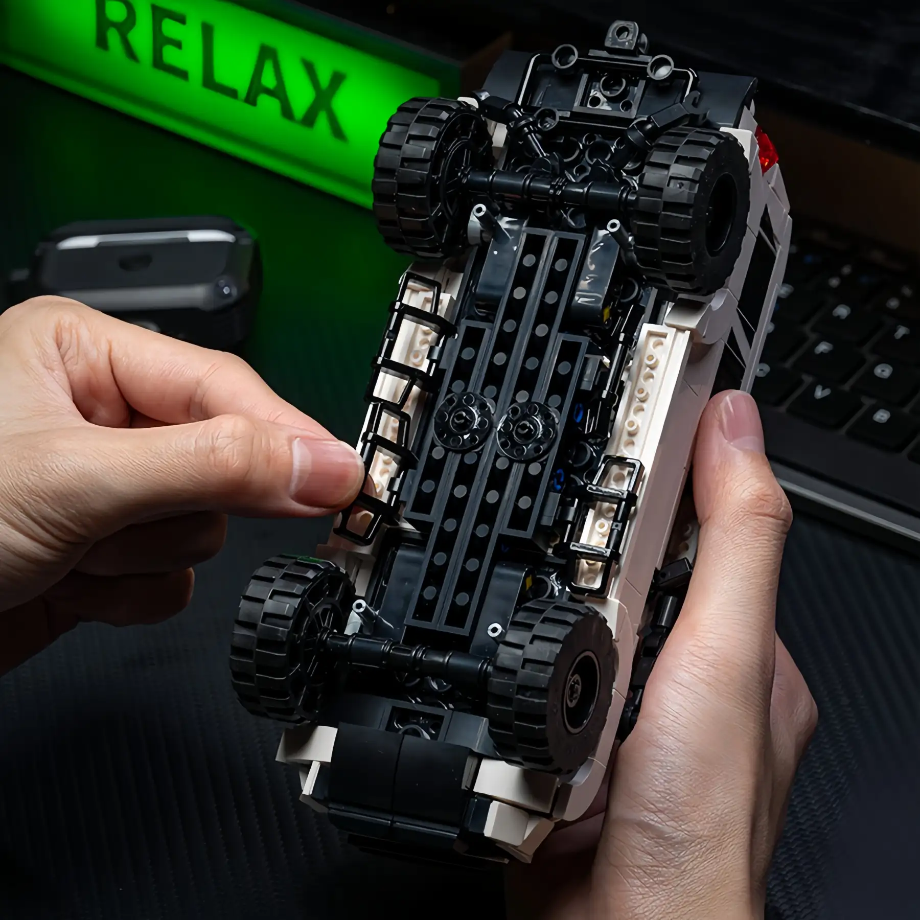 Underside chassis detail shot of Toyota 4Runner Off-Road SUV Brick Model with green ambient light, 540 PCS collectible construction set