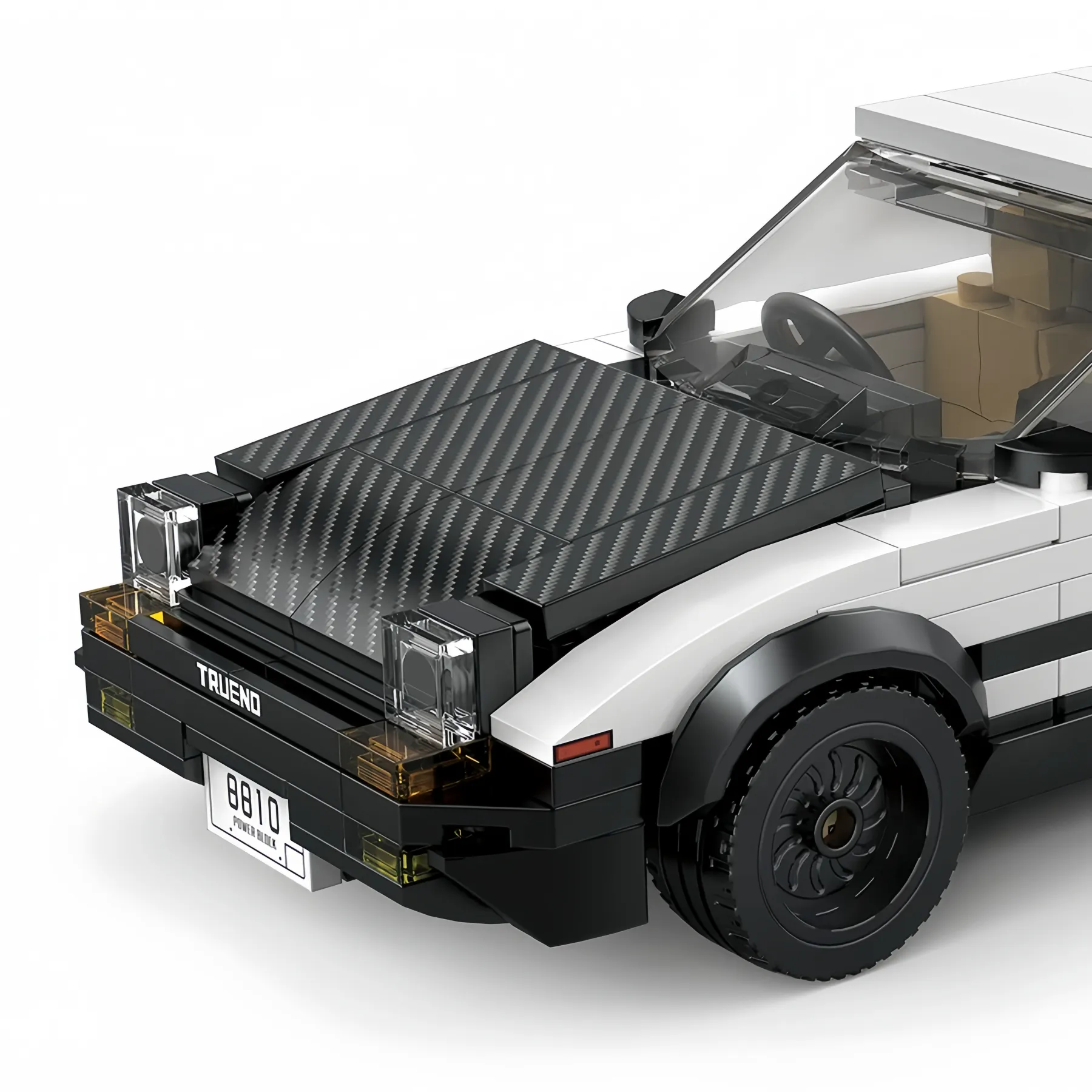 Close-up view of the Toyota AE86 brick model car showing the carbon fiber pattern hood, pop-up headlights, and Trueno badge.