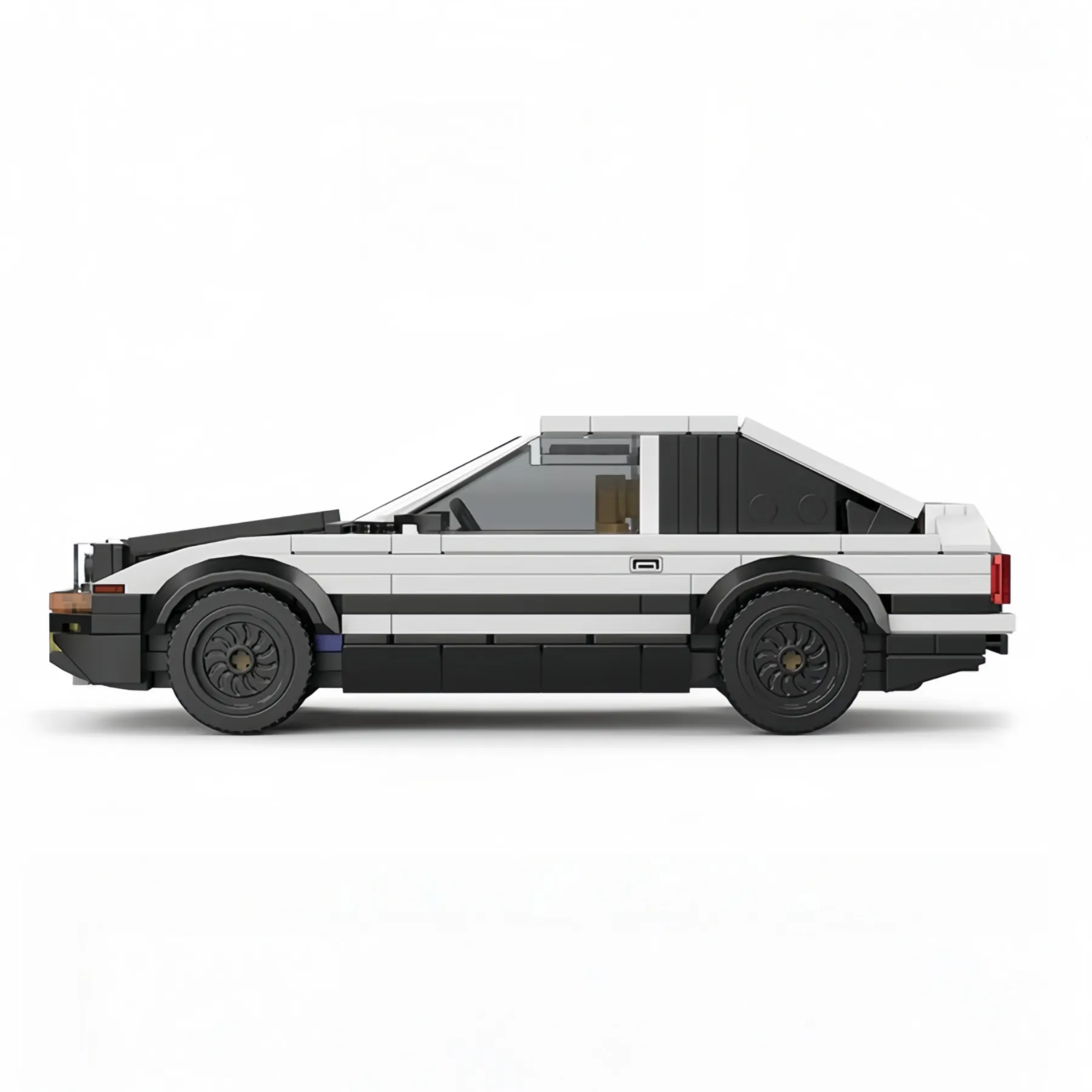 Side view profile of the Toyota AE86 Trueno brick model car in classic black and white panda livery.