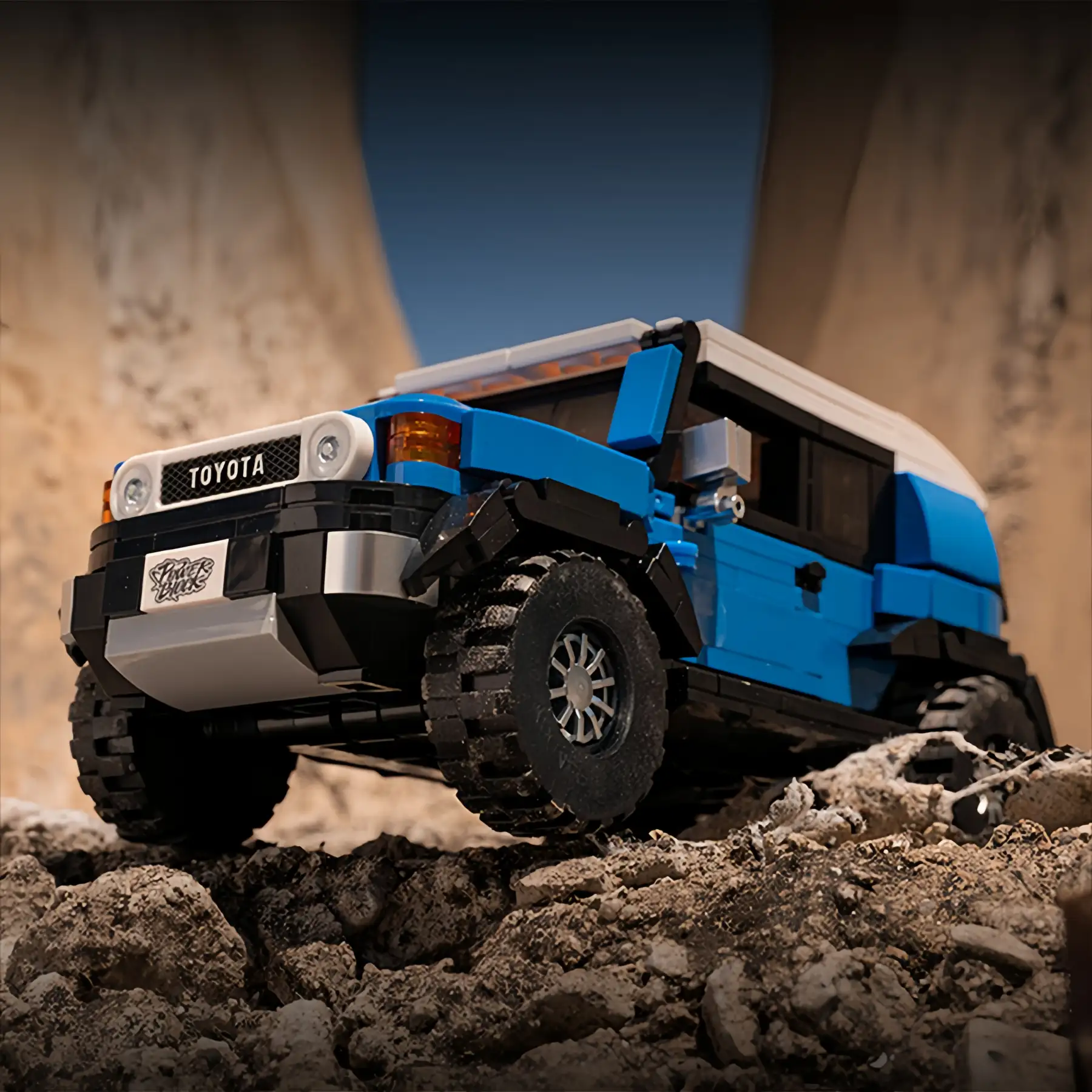 Blue Toyota FJ40 Retro Land Cruiser brick model on rocky terrain, 622-piece collectible construction set, off-road display