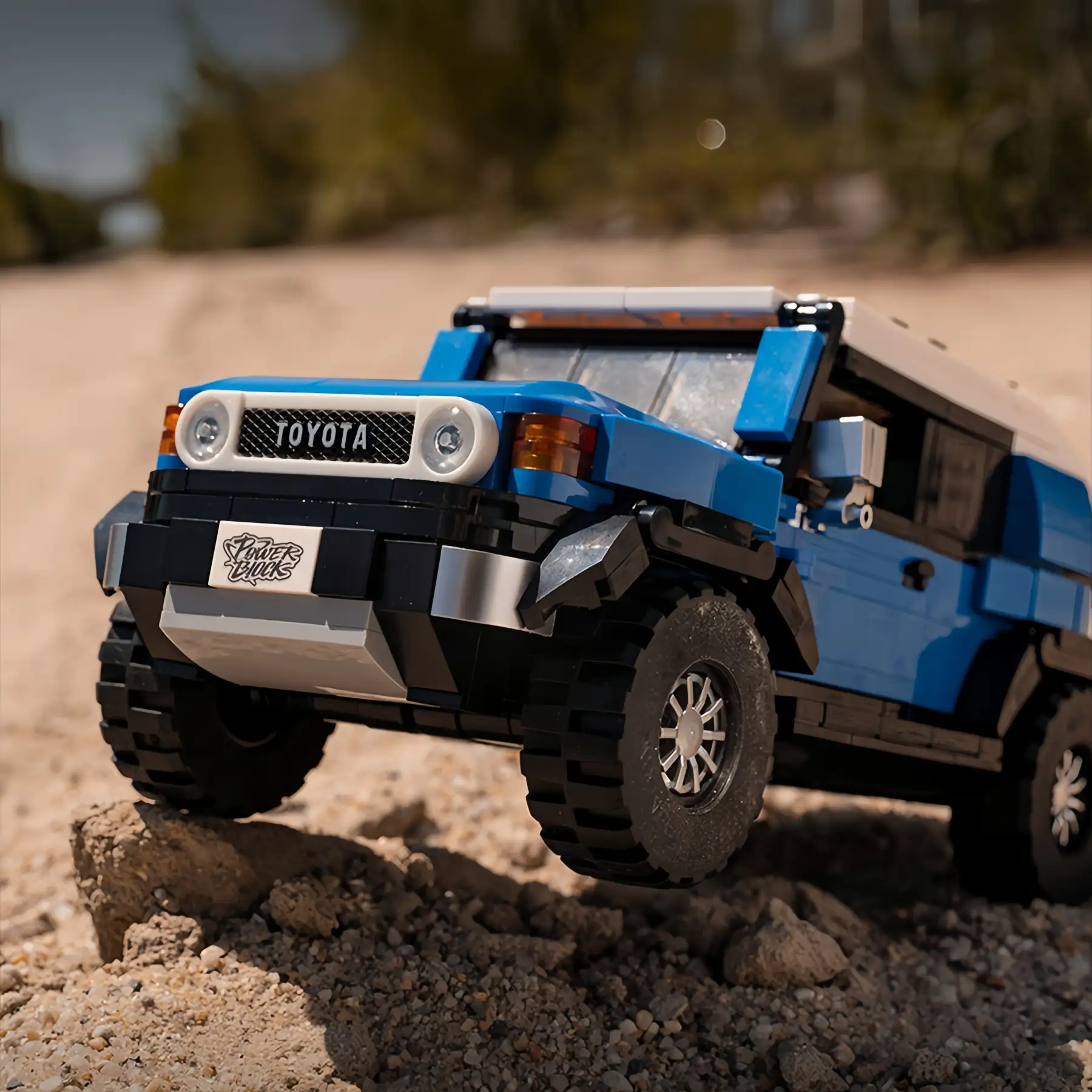 Blue Toyota FJ40 Retro Land Cruiser Brick Model on sandy off-road terrain, 622 Pieces Display-Ready Collectible Construction Set