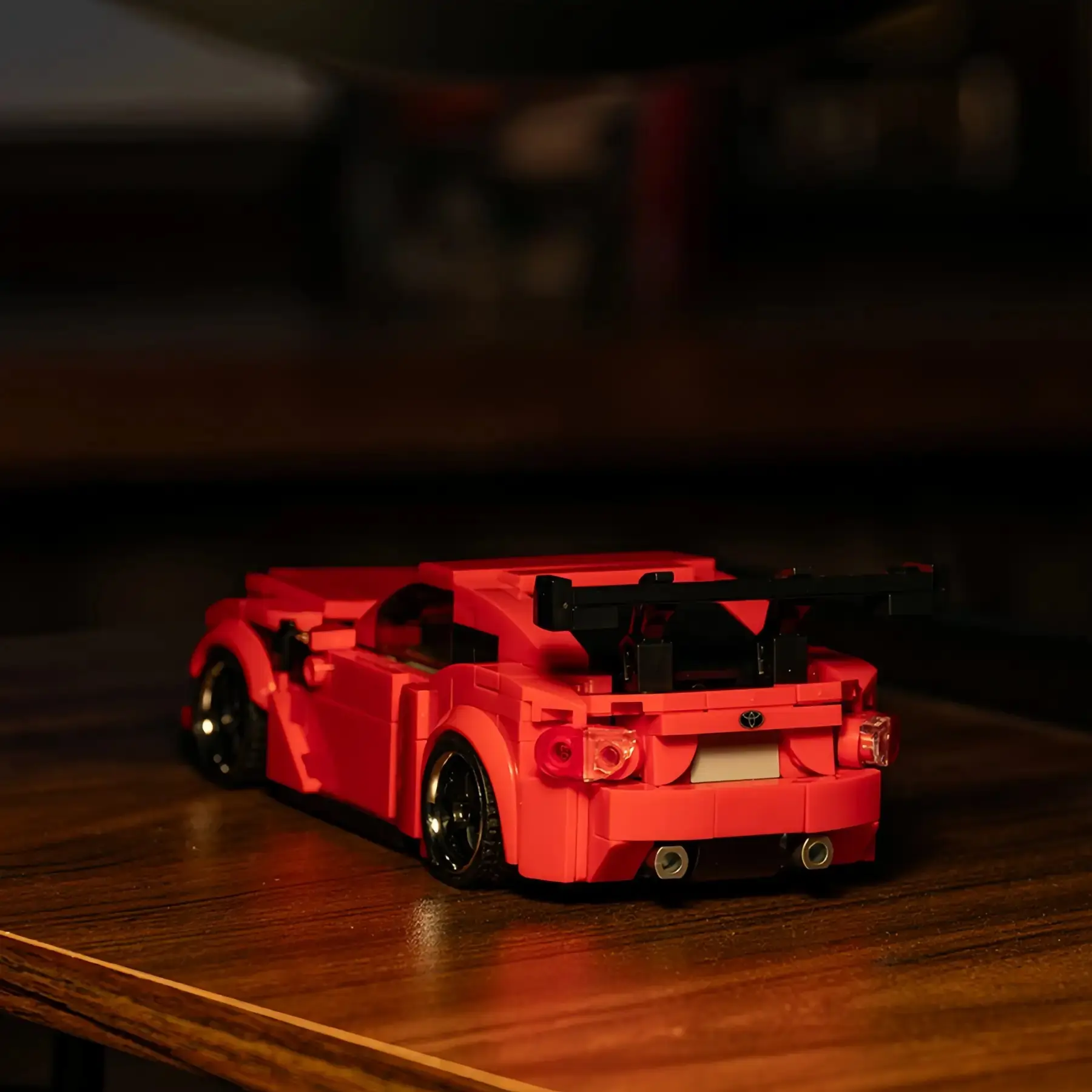 Close-up rear detail of the Toyota GT86 brick car showing the black racing wing, custom license plate, and dual exhaust blocks.