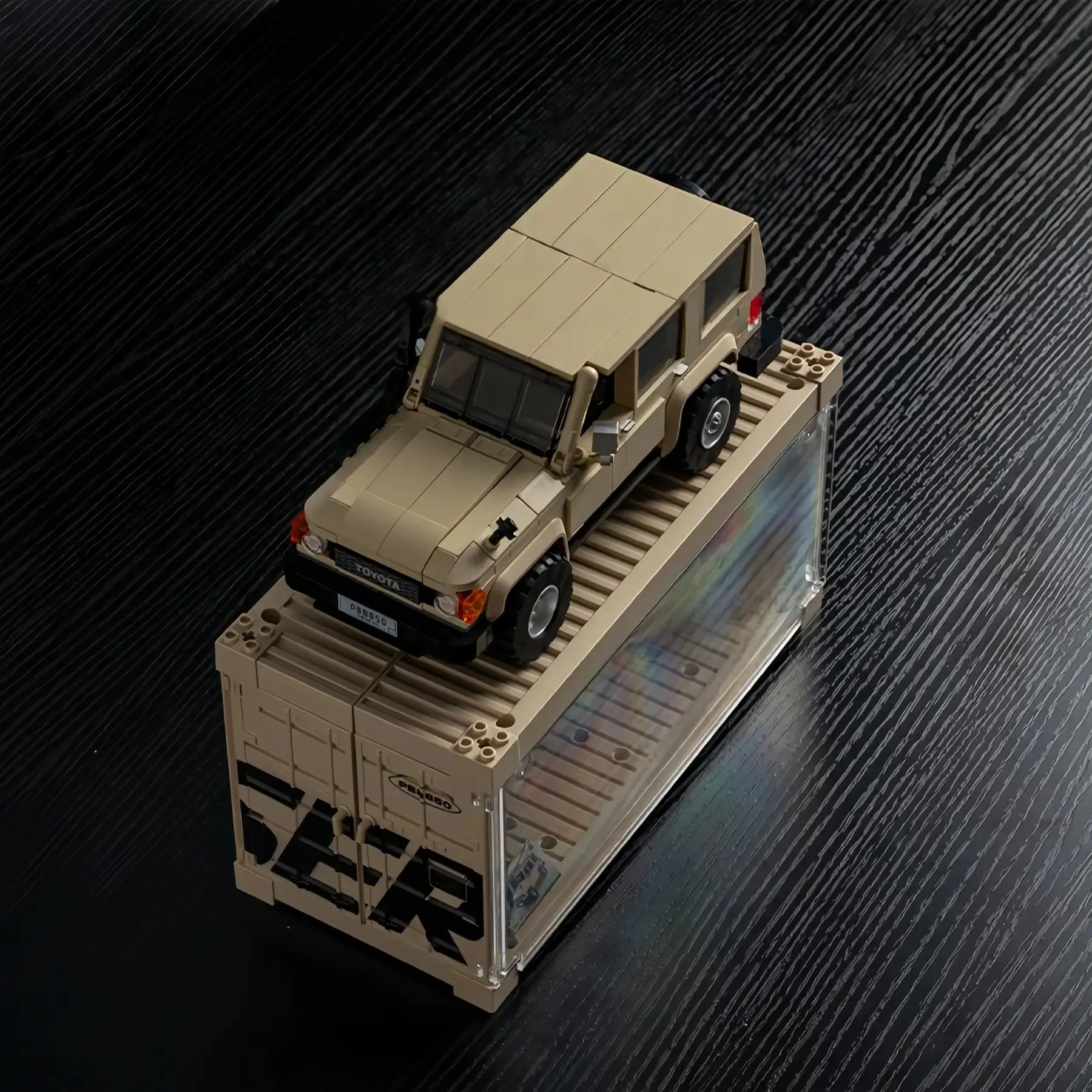 Toyota Land Cruiser brick car parked on top of its branded cargo container case.
