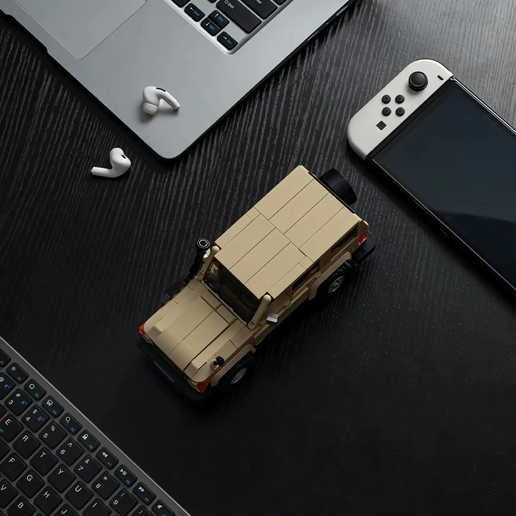 Top-down view of Toyota Land Cruiser LC78 brick model off-road SUV on a wooden desk.