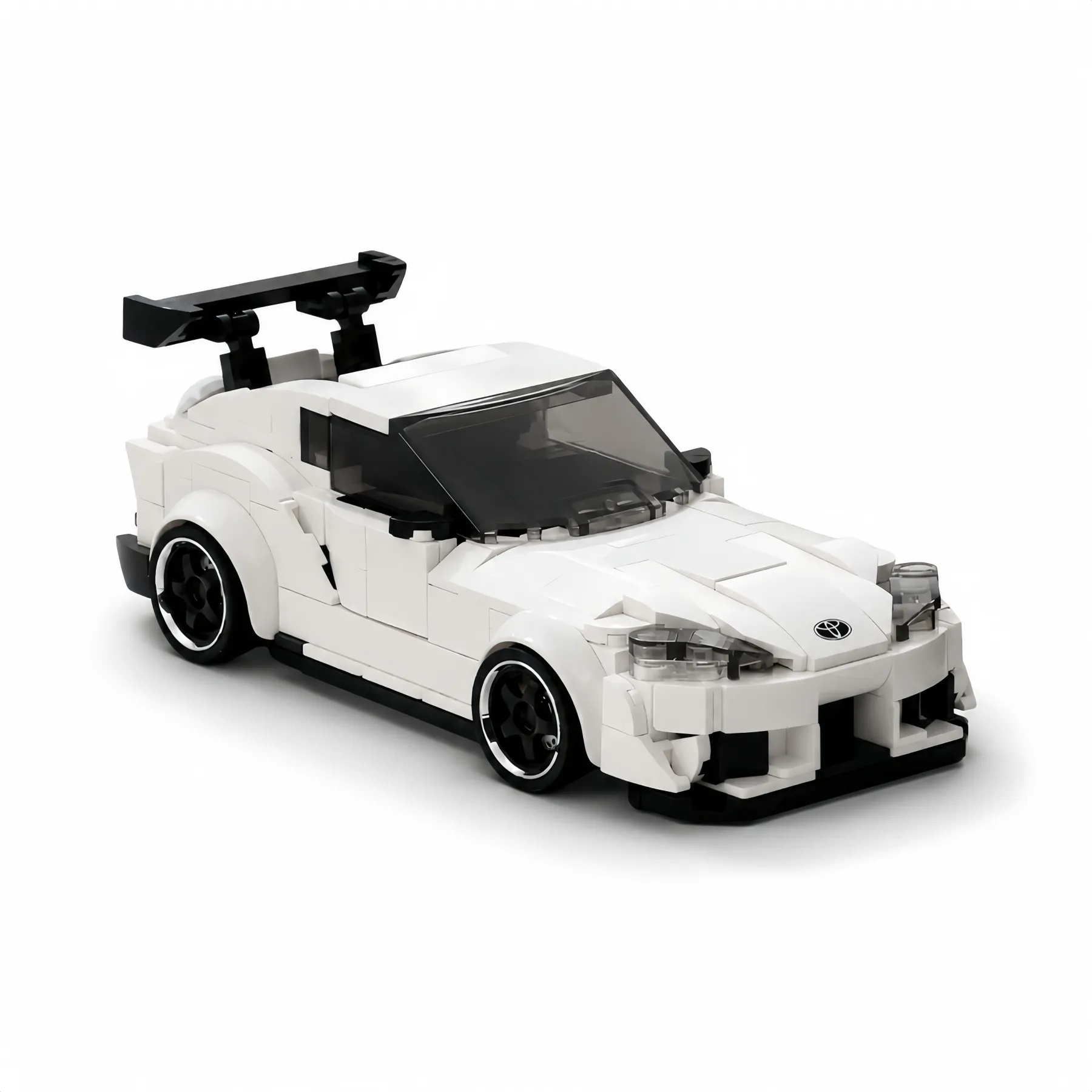 White Toyota Supra Bull Demon King JDM sports car building blocks model with large black racing spoiler wing, isolated on a white background.