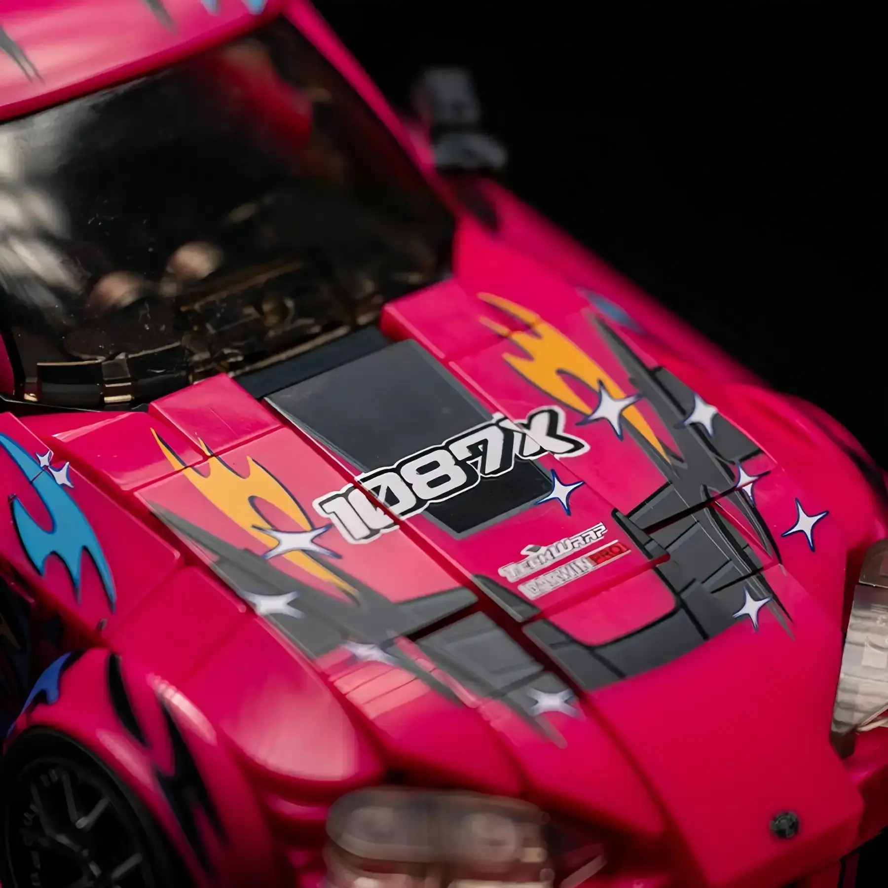 Macro view of the 1087X racing graphics and hood decals on the Toyota Supra MK5 brick model.