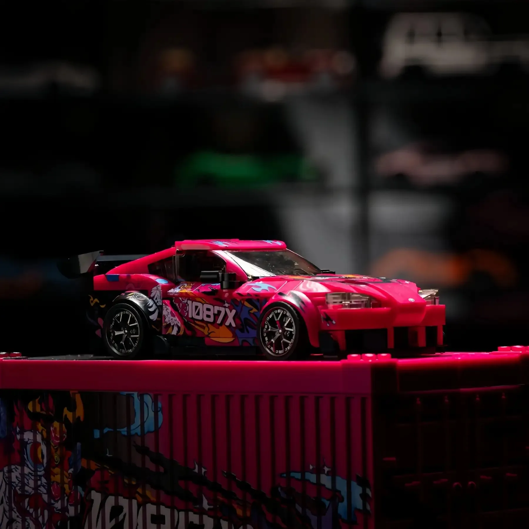 Toyota Supra MK5 brick car model parked on top of its pink 1087X container display box.